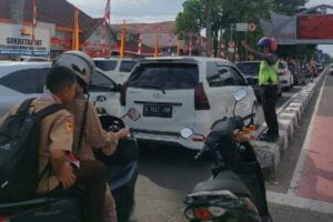 Polisi melancarkan arus lalu lintas yang tersendat di salah satu ruas jalan Jenderal Sudirman. (Foto: Dok. Radarsumbar.com/Herru Iriawan)