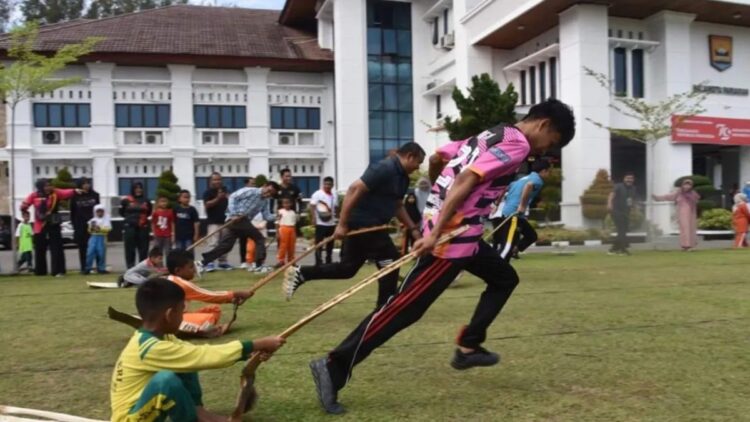 Peserta lomba sedang memainkan permainan tradisional pacu upiah pada pelaksanaan Lomba Olahraga Tradisional tingkat SD di Kota Pariaman, Sumbar pada Rabu (25/9). Antara/HO-Diskominfo Pariaman